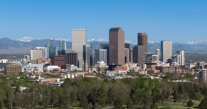 The Denver skyline with the Rocky Mountains behind it