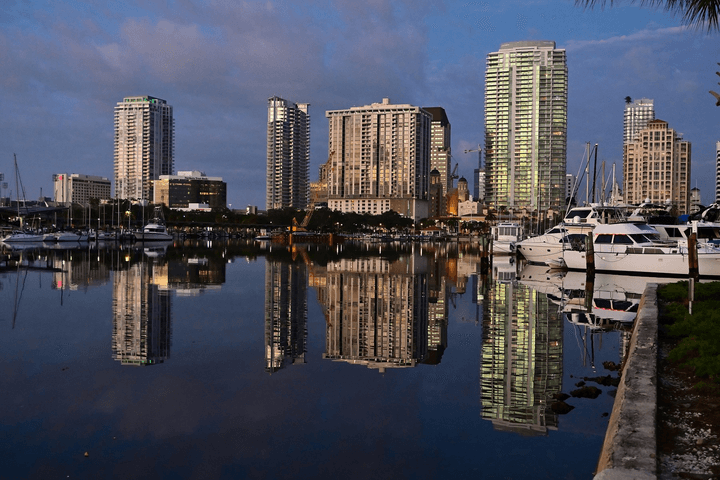 The St. Petersburg skyline at sunrise, reflected in the marina